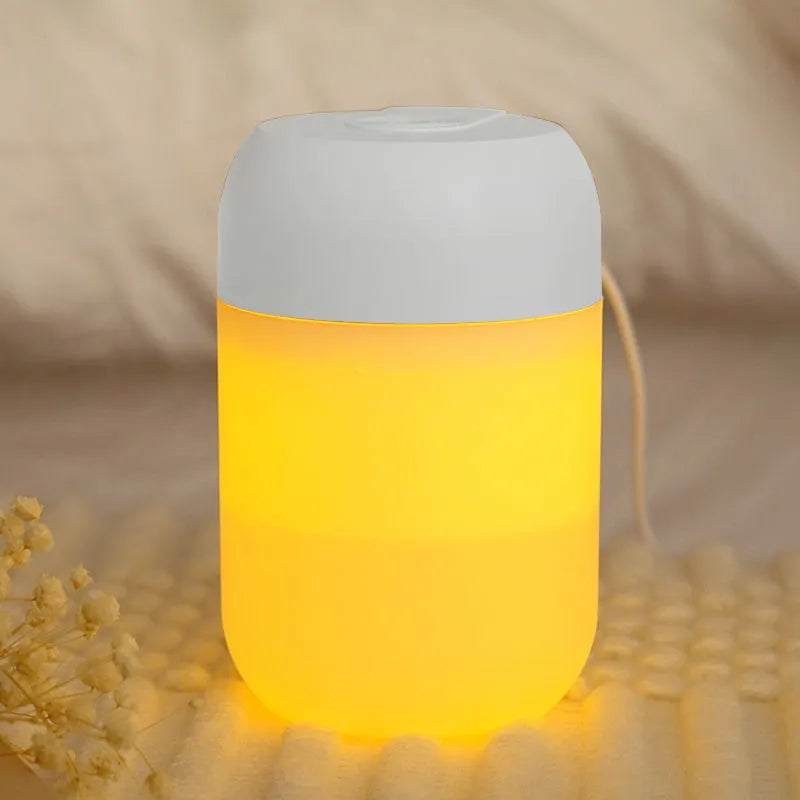 White cylindrical USB-powered small humidifier with aromatherapy function on wooden desk