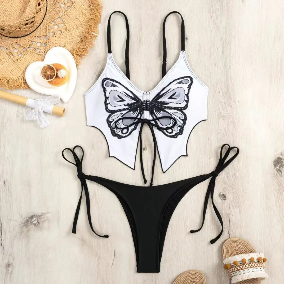 Women's purple bikini suit with bow ins style detail on a split design, made from polyester fabric.