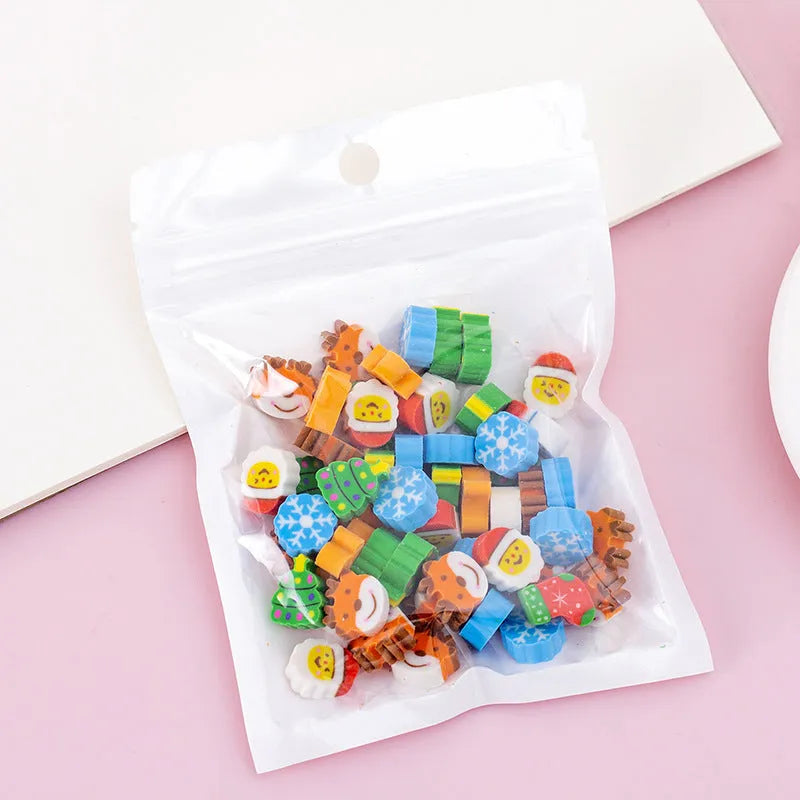 Assortment of fifty small cartoon-shaped rubber erasers in fruit and animal designs.