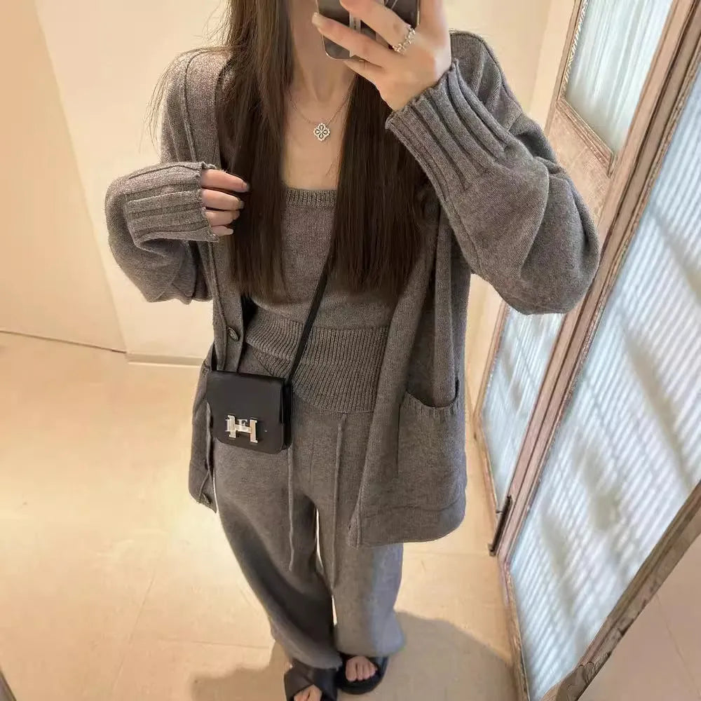 Women's light brown knit cardigan three-piece set with suspender casual pants on a hanger.