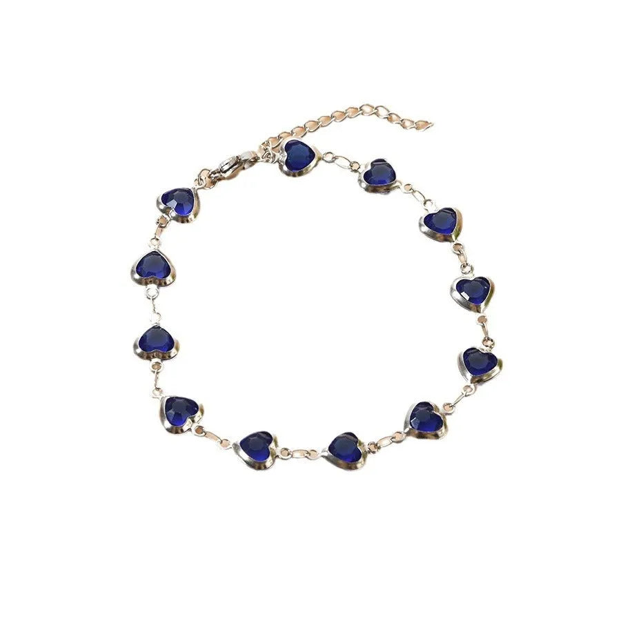 Stainless steel heart-shaped bracelet with electroplated geometric design in various colours like red, blue, and green for unisex wear.