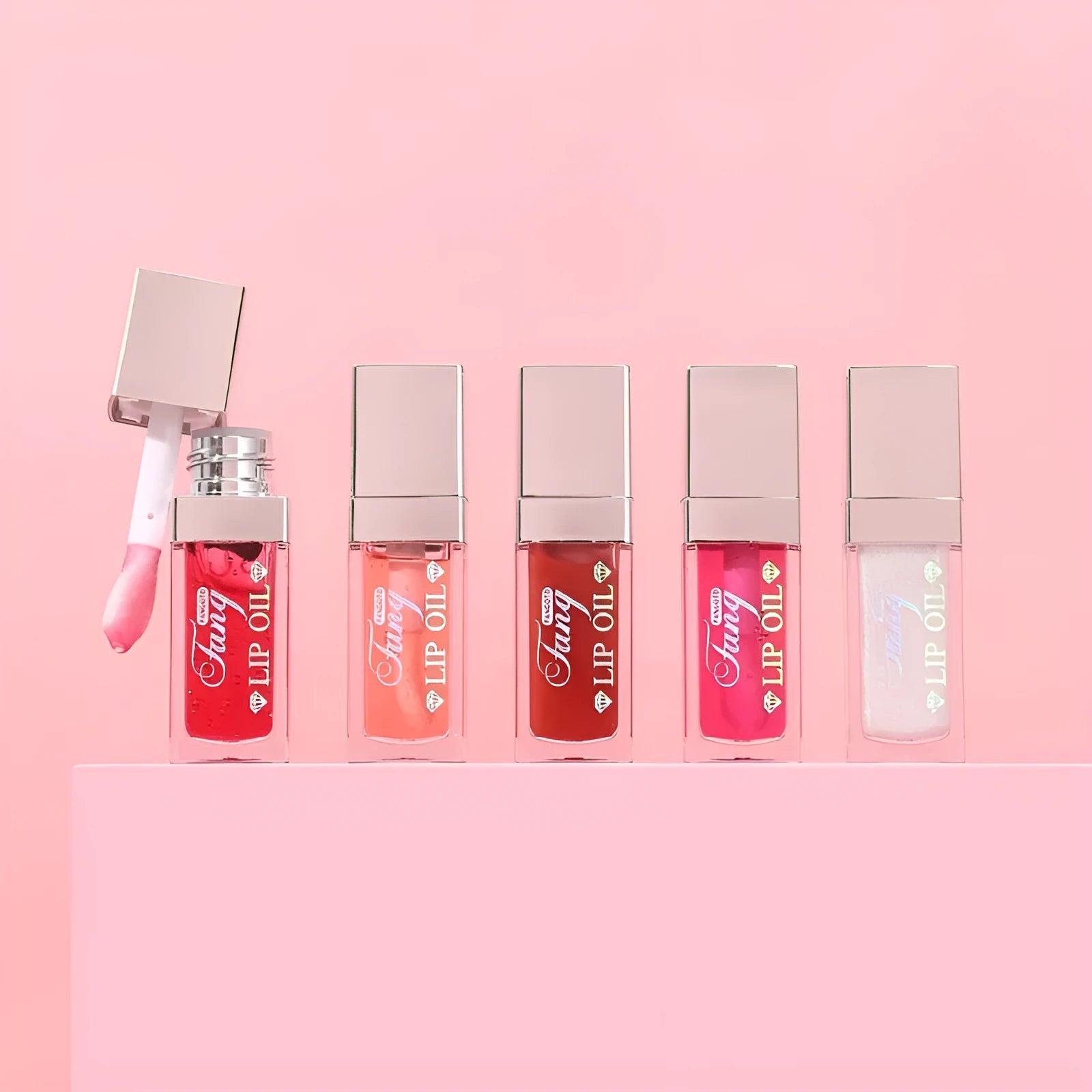 Mint lip gloss tube in one of five colours including bright pink, orange and dark red.