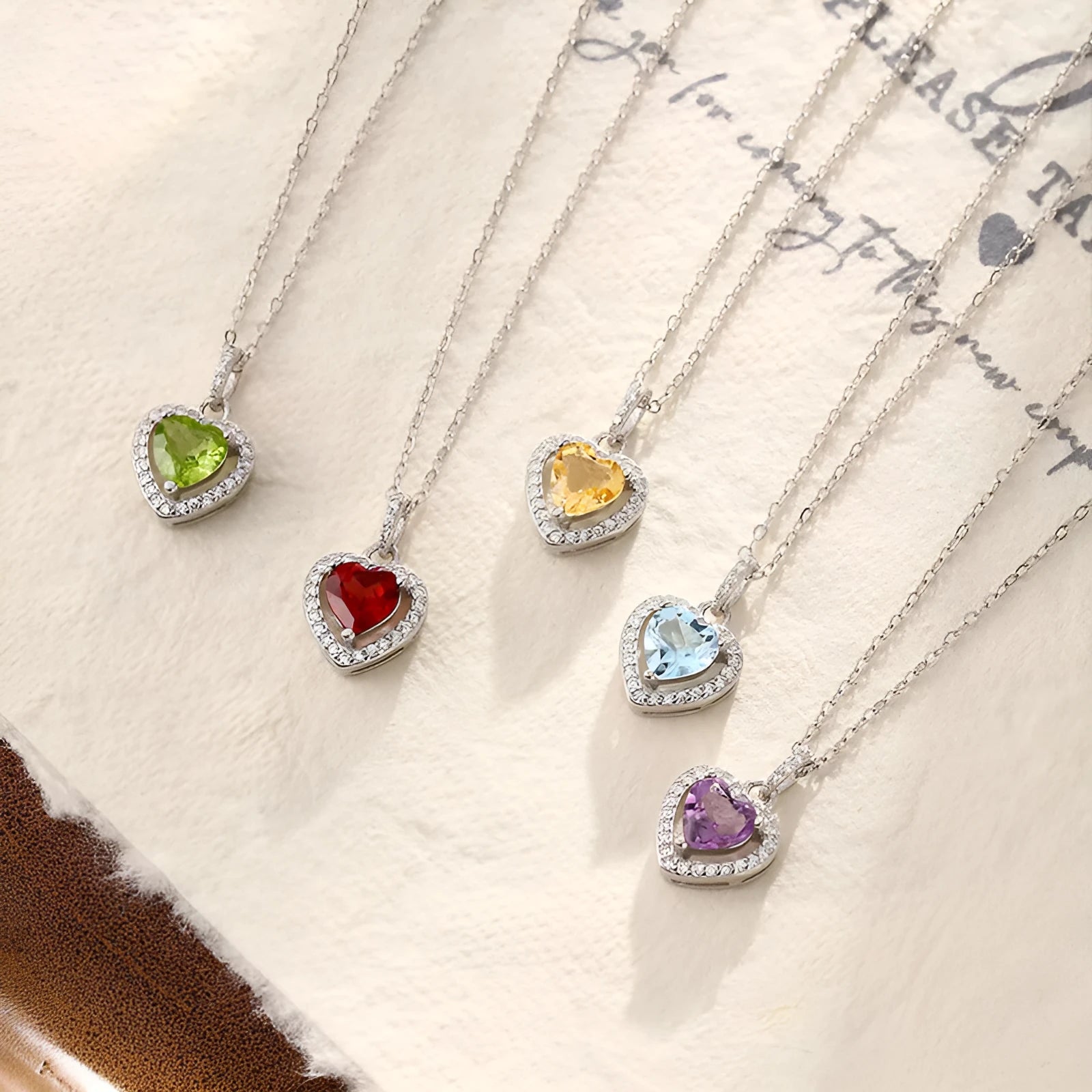 Women's sterling silver heart pendant necklace with natural coloured gemstone on cross chain