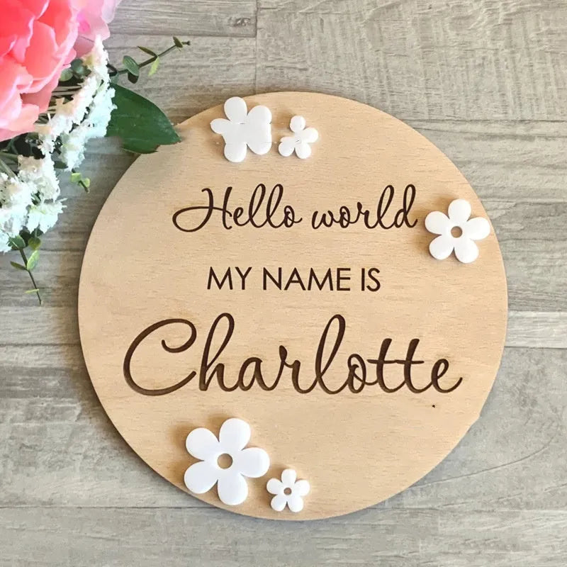 Square wooden baby name sign with birth information, 15 cm wide, in one of three style variants.