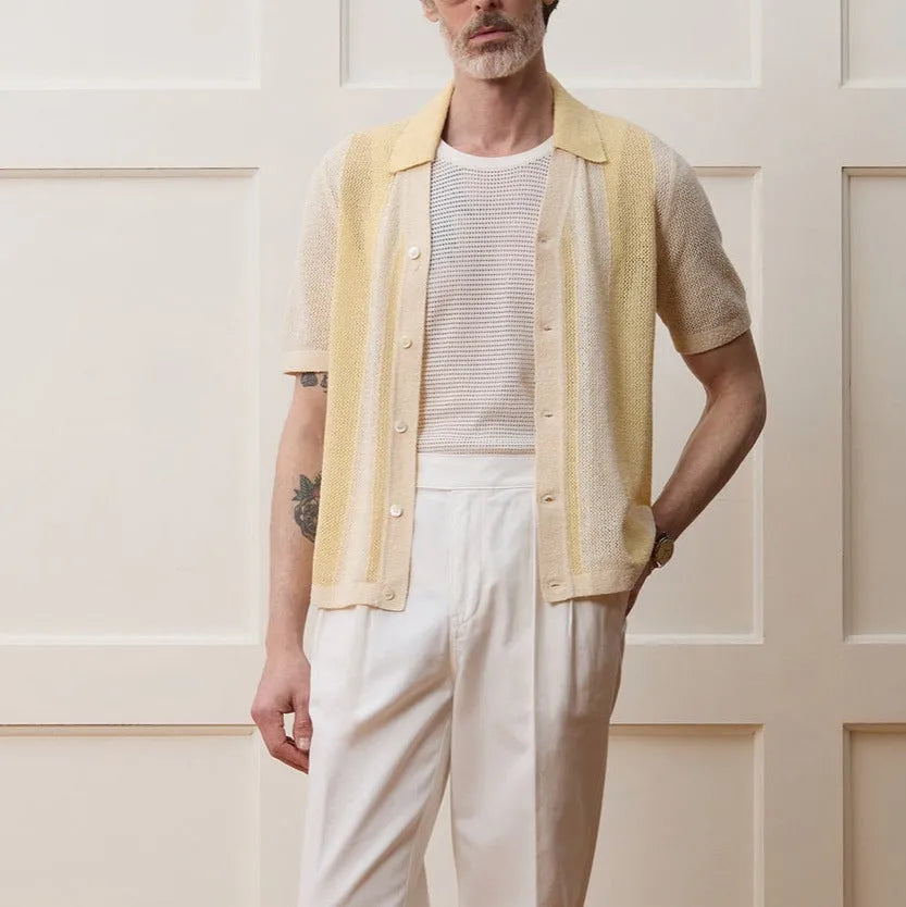Yellow short-sleeved polo shirt with asymmetric design and hollow-out pattern details