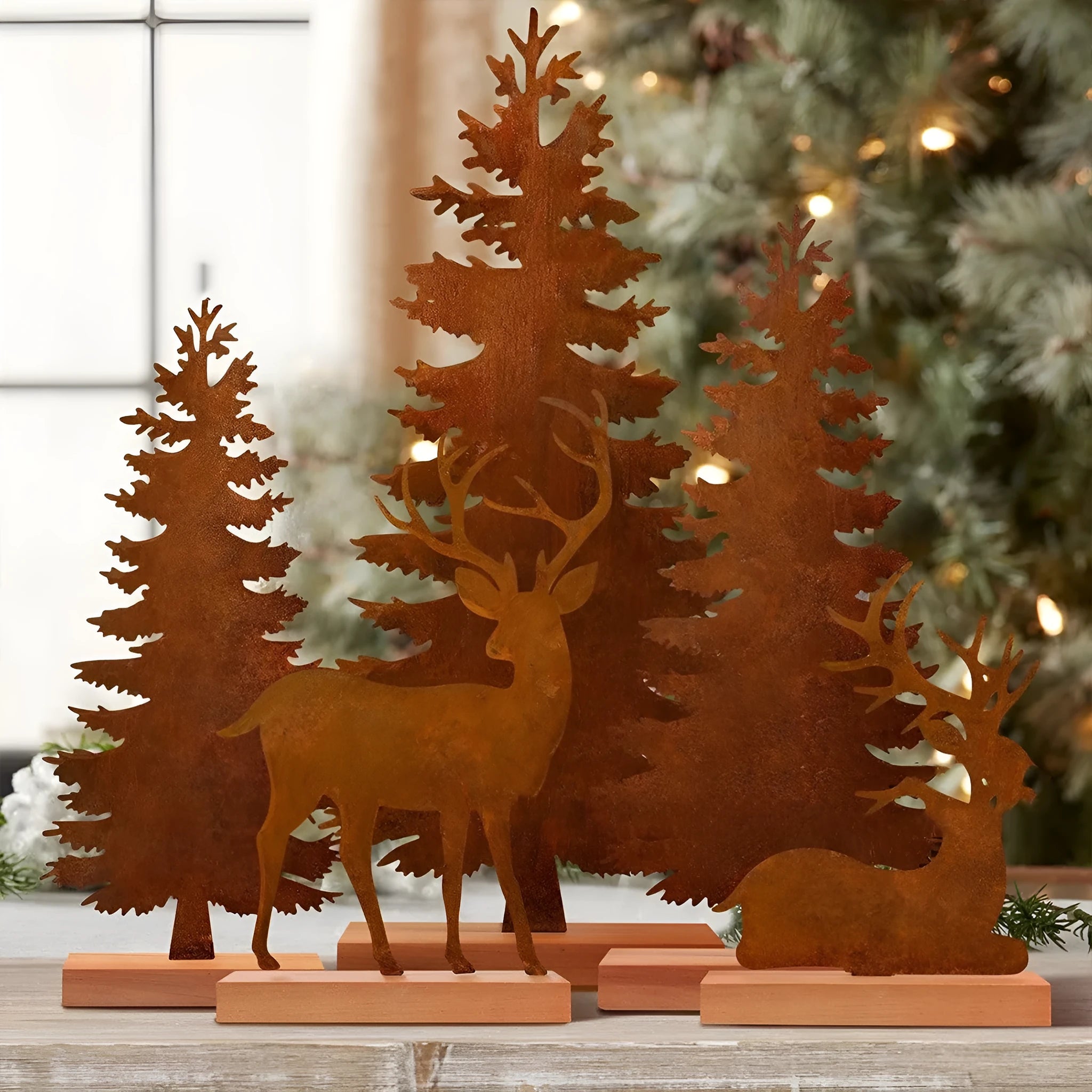 Three metal Christmas tree ornaments with elk figurines and rustic metallic finish