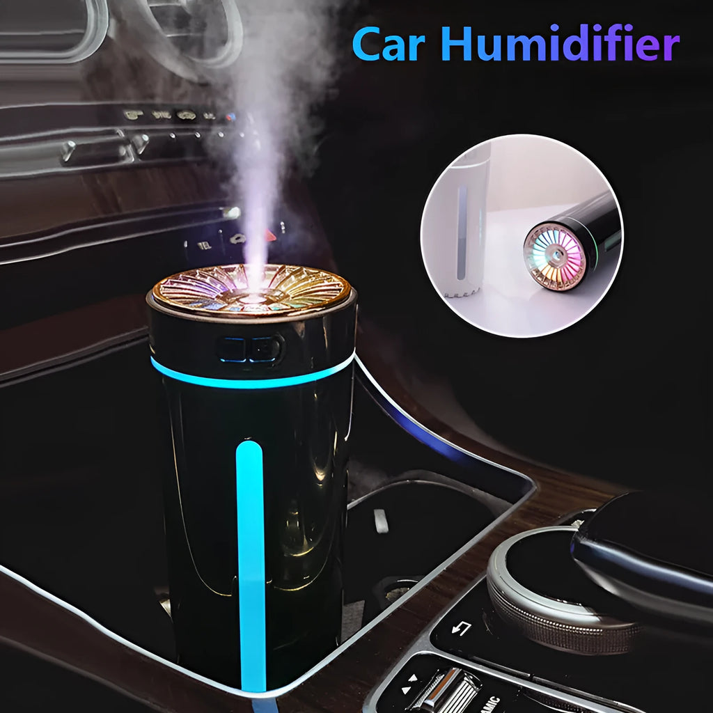 Black and white portable USB rechargeable humidifier with colourful LED lights on a car cup holder.