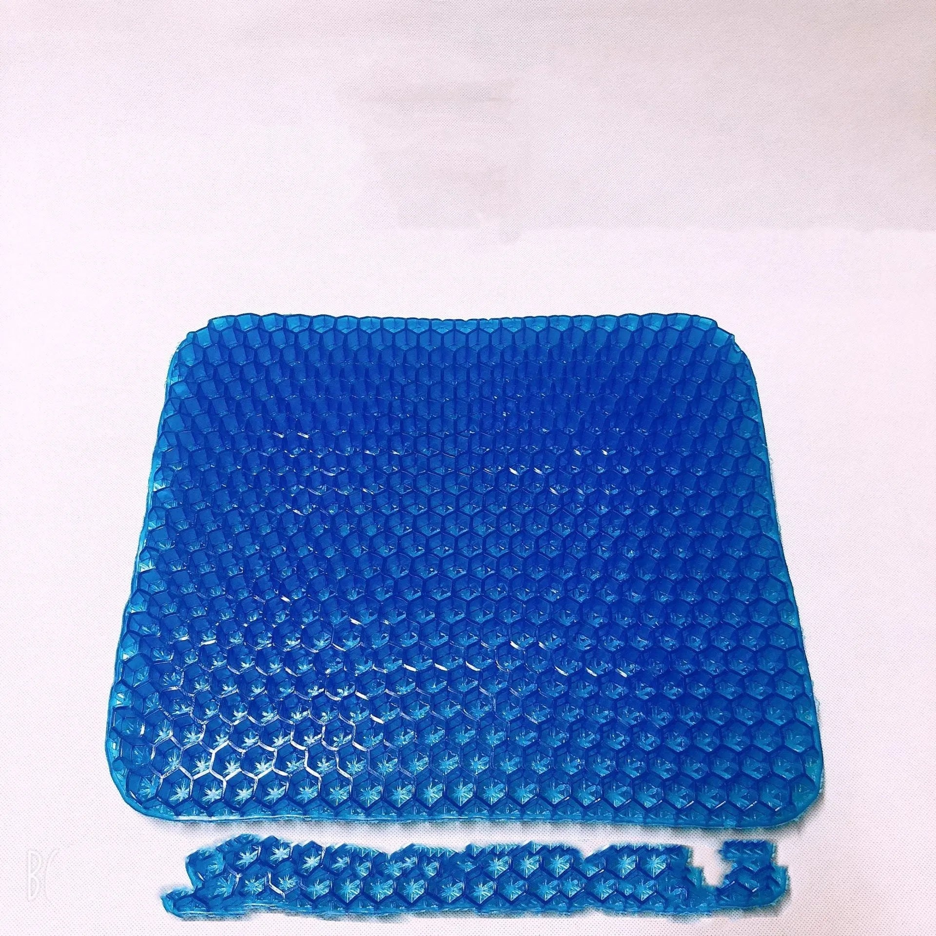 Gel seat cushion with honeycomb pattern and removable blue PVC cover for pressure relief.