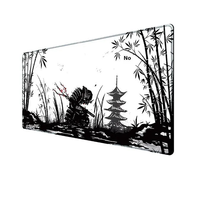 Japanese samurai design gaming mouse pad with cloth surface on a desk.