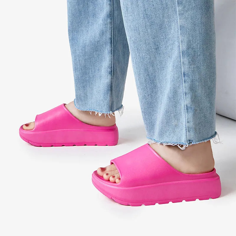 Women's beige fish mouth slippers with a thick 5.5cm EVA platform sole on a wooden floor.