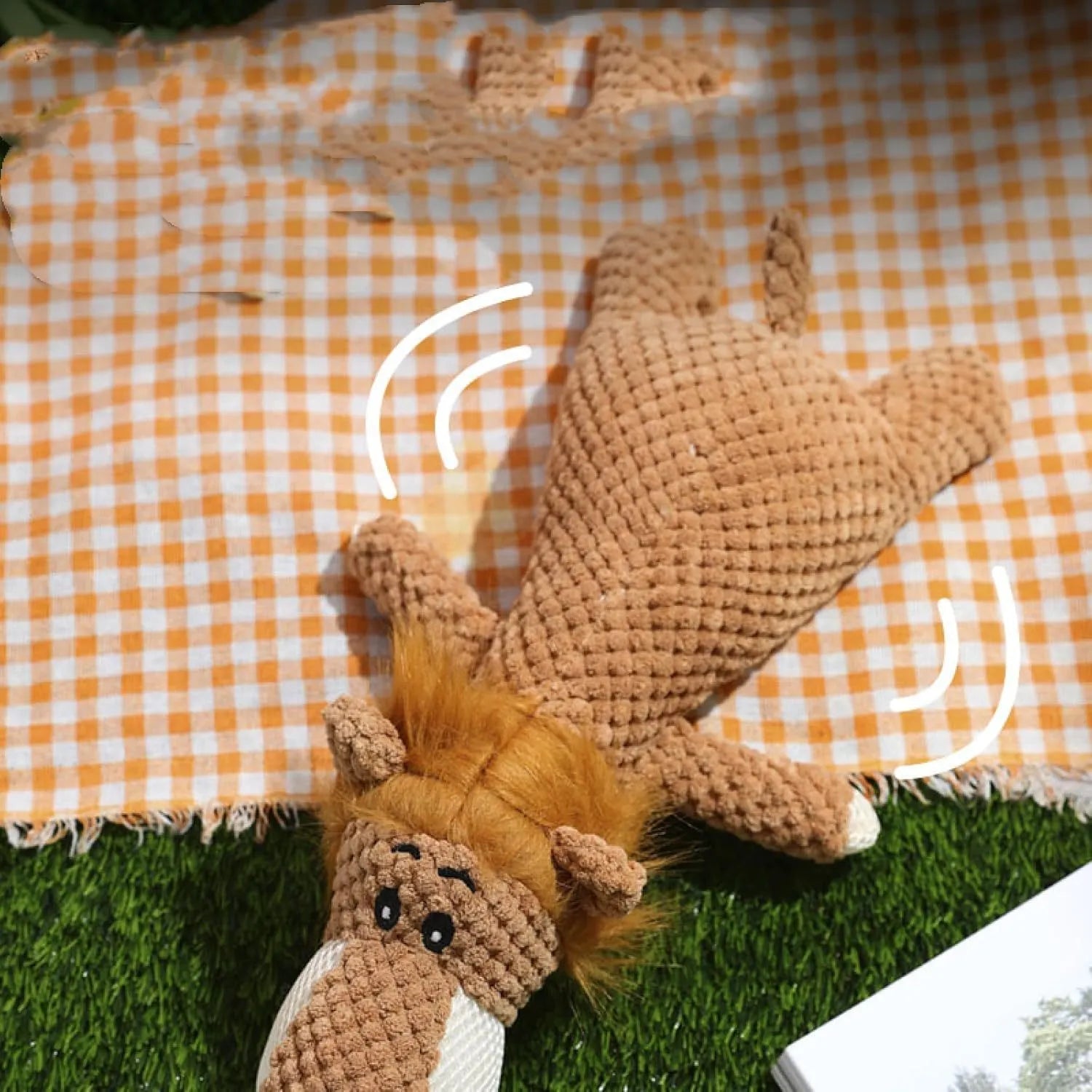 Grey plush dog toy shaped and textured like an ear of corn with visible kernels, lying on a plain surface.