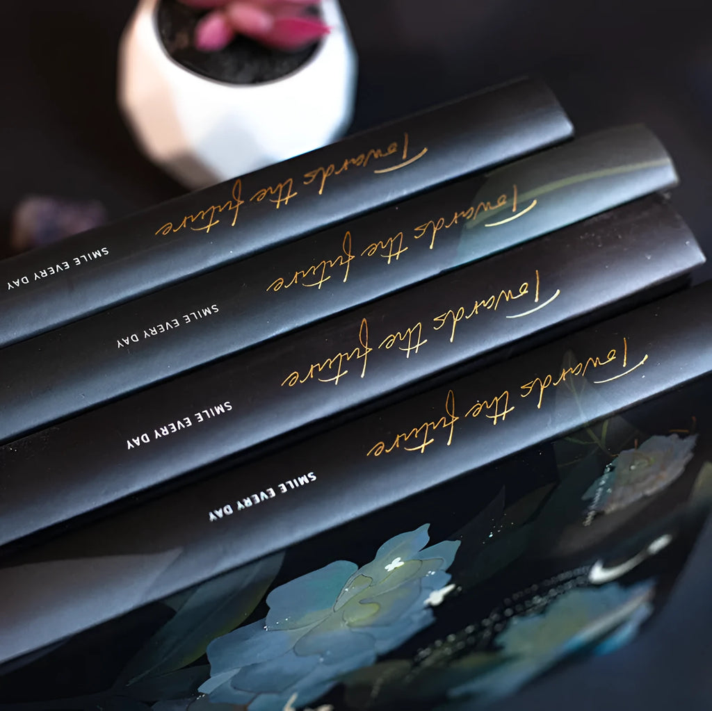 A5 notebook with luminous cover showing colour illustration pages inside, available in Deep Blue, Gold, Light Blue, or Purple colours