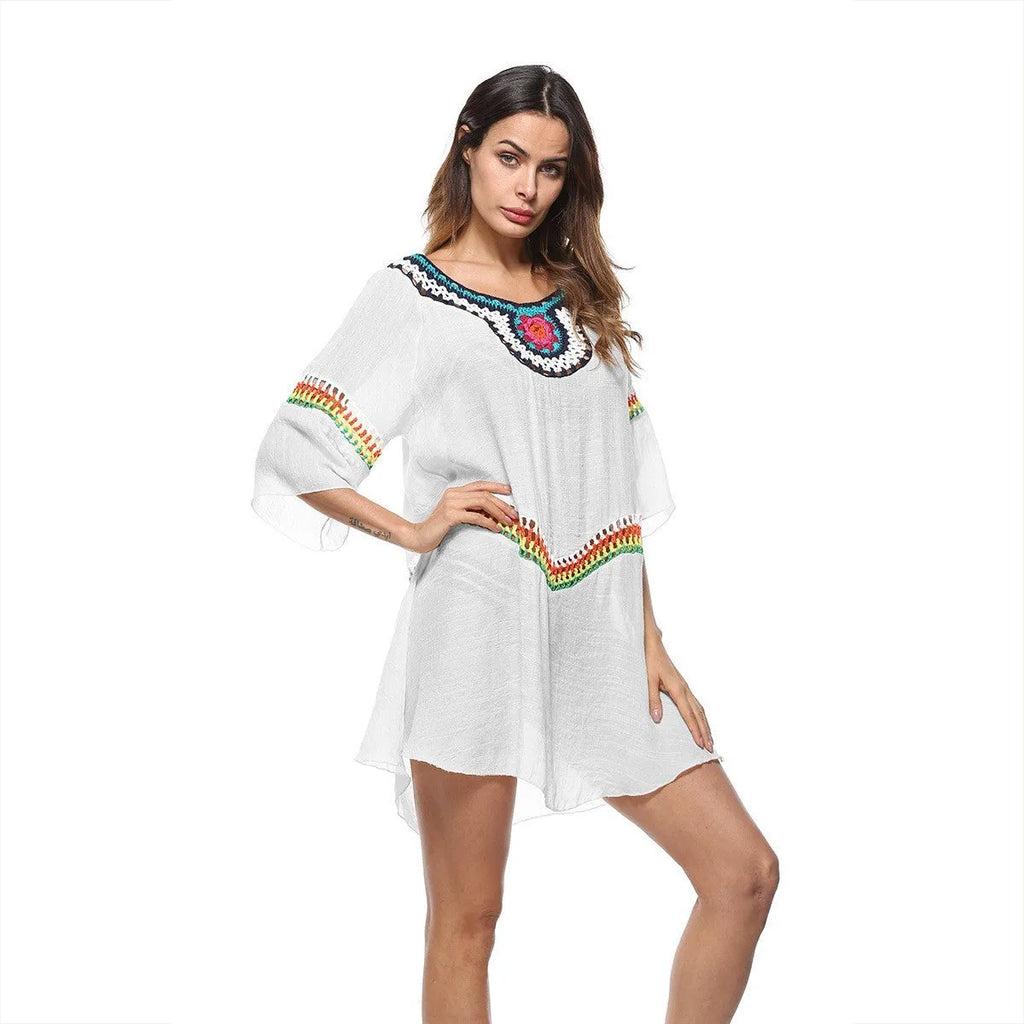 Crocheted white ethnic-style beach cover-up for women, shown as sun protection clothing.