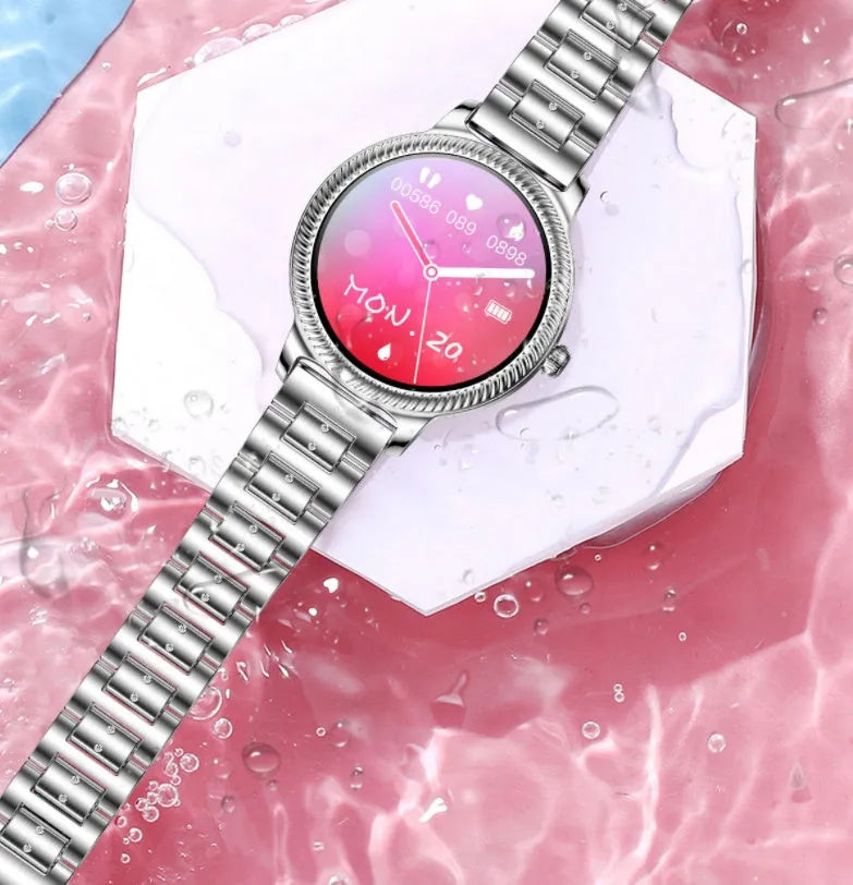 AK38 ladies smart watch with stainless steel Milanese band on wrist, showing its colour screen