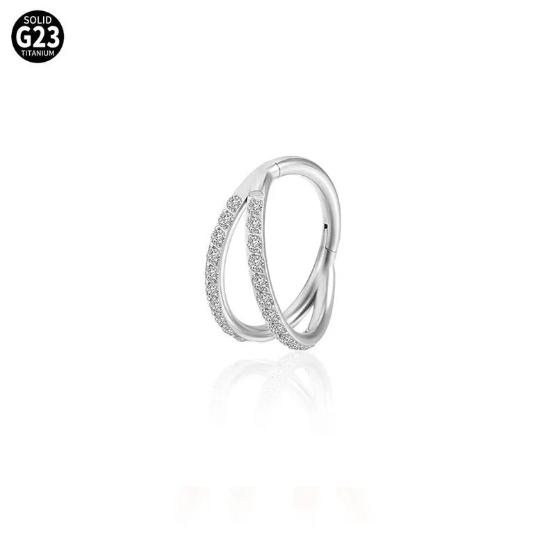 Close-up of a G23 titanium alloy nose or ear ring with a small zircon gemstone, shown in a gold tone finish.