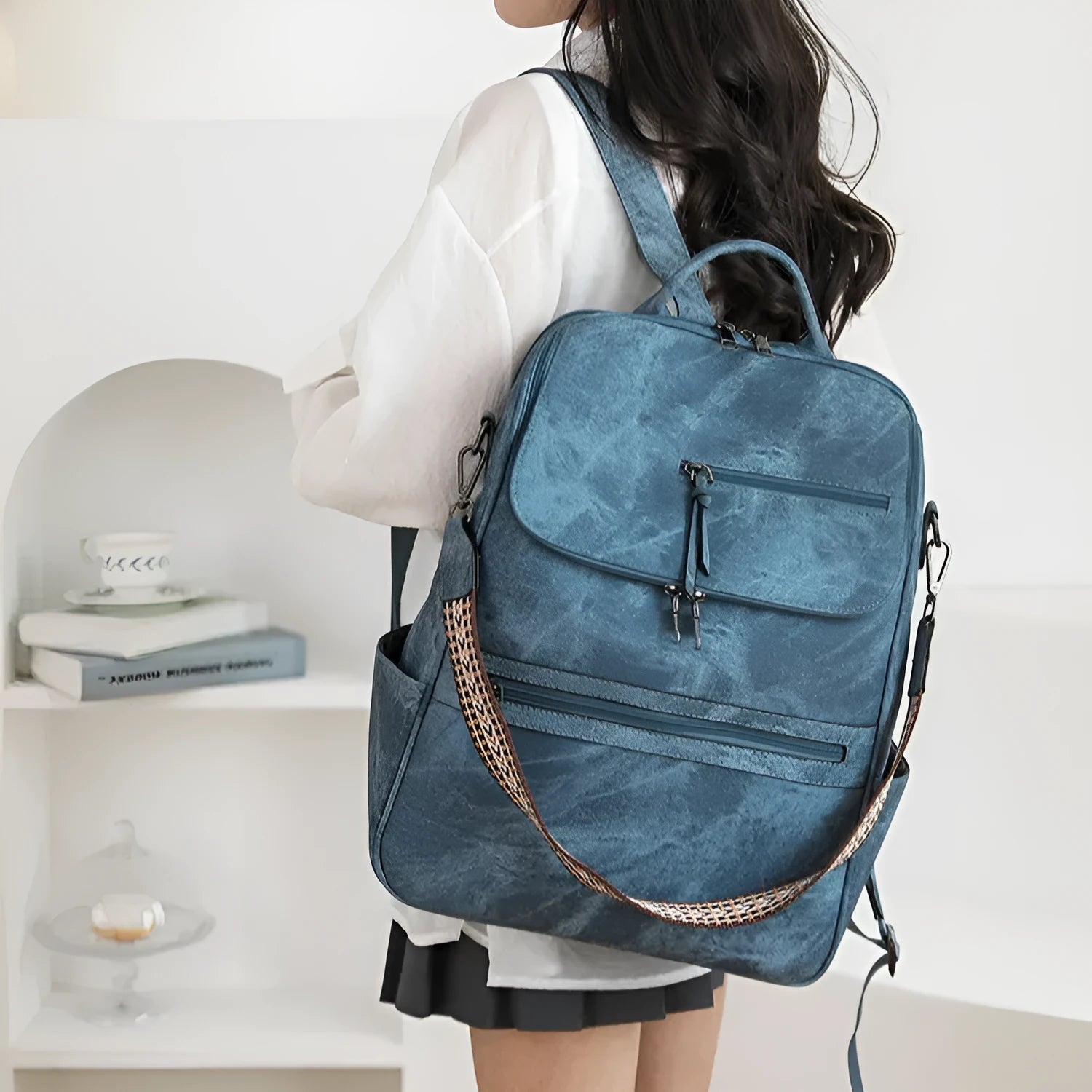 Retro college student backpack in black with curved shoulder straps and stitching detail