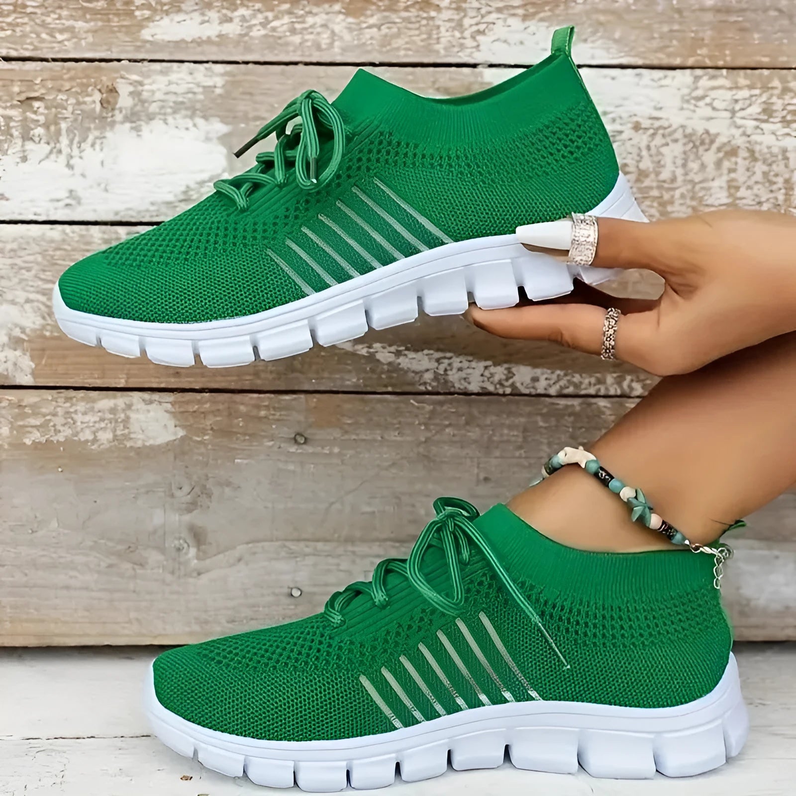 Breathable women's casual flat shoes in flying knit mesh with front lace tie.