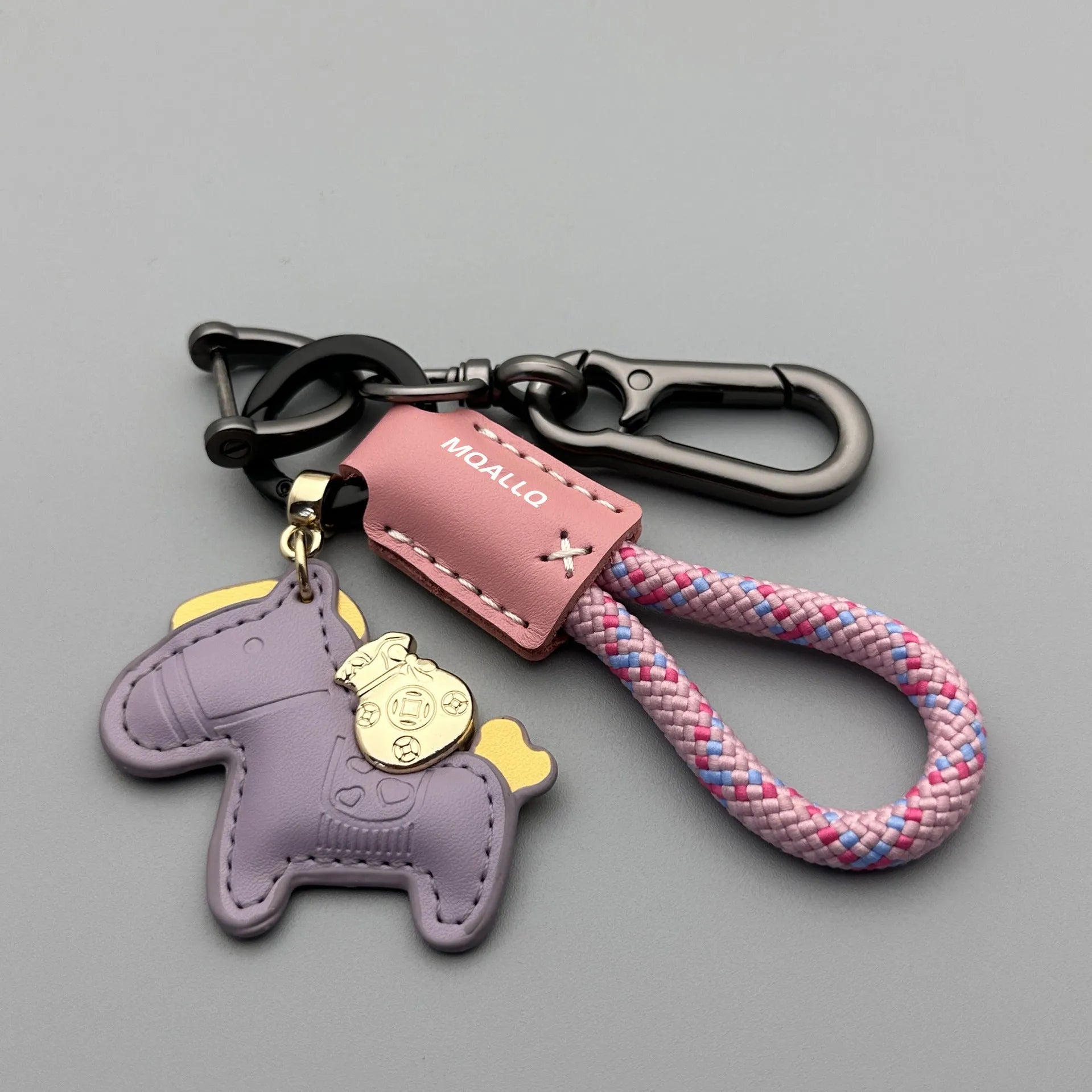 Handmade brown cowhide key pendant with a green flannel rope and a gold-toned horse-shaped buckle.
