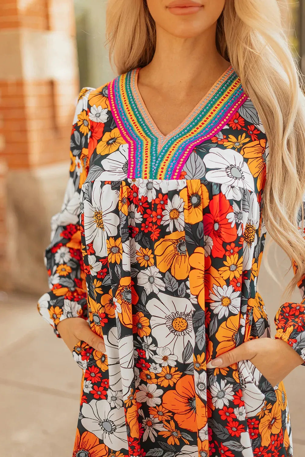 Orange floral print women's mini dress with striped lace detailing, v-neck, and long sleeves