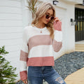 Women's pink and white striped loose fit short sleeve acrylic pullover on a hanger.