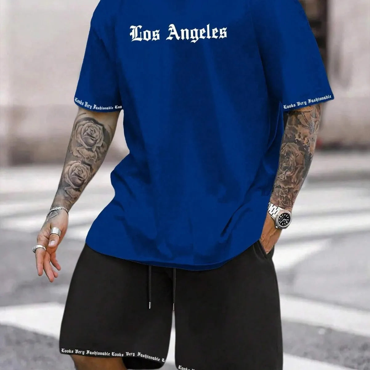 Sports style short-sleeved top and matching shorts set laid flat, showing thin polyester blend fabric.