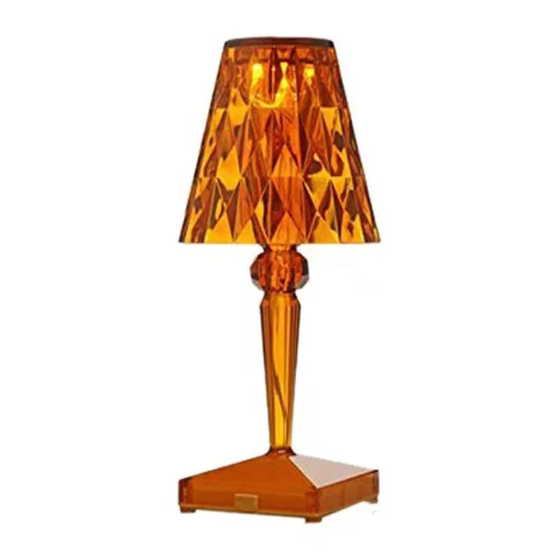 Rose gold portable touch projection night light with acrylic lamp holder on wooden surface