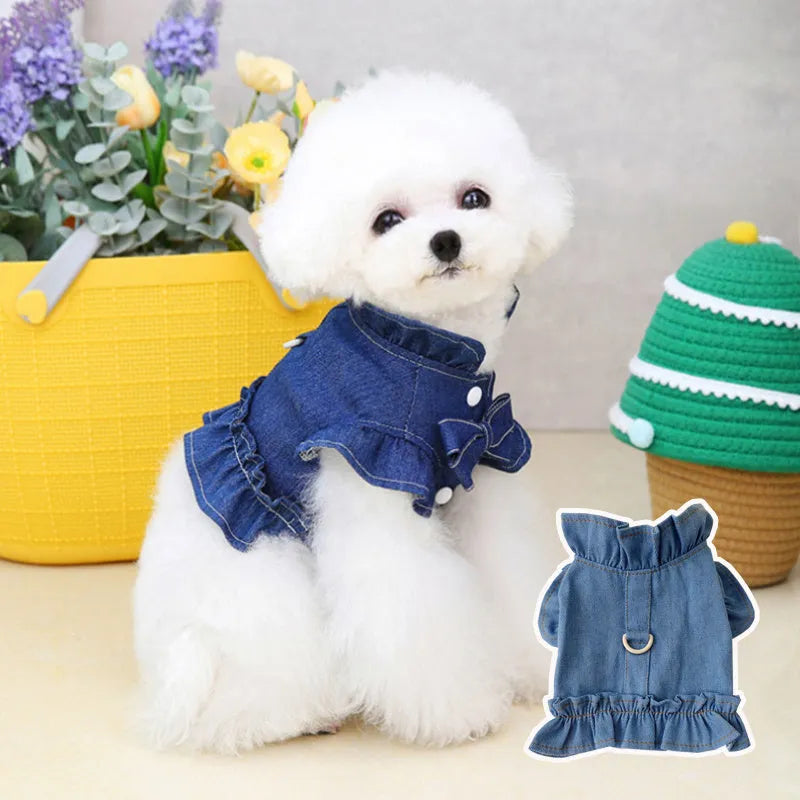 Blue denim dog dress with a ruffled vest design and a metal leash hook on the chest.