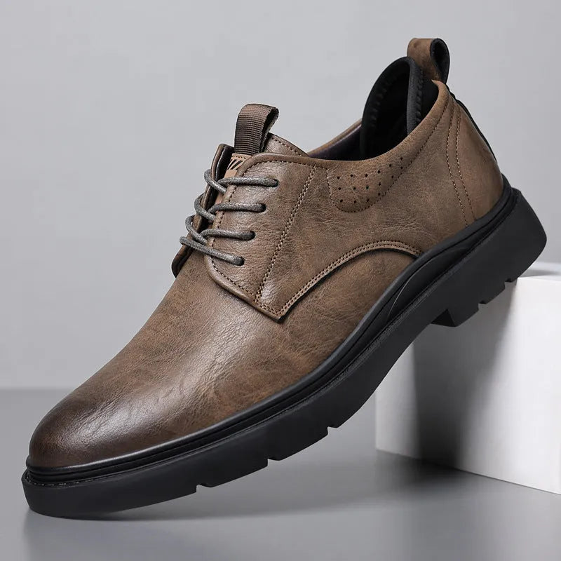 Men's black and brown leather casual sneakers with visible sewing line detail on the cowhide upper.