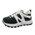 Low-top white and black casual sneakers with round toe and lace-up front