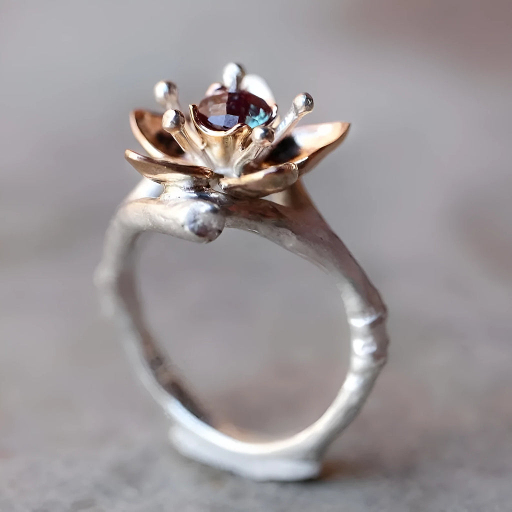 Women's two-tone floral alloy ring in silver on a light background, geometric shape, ornamental design