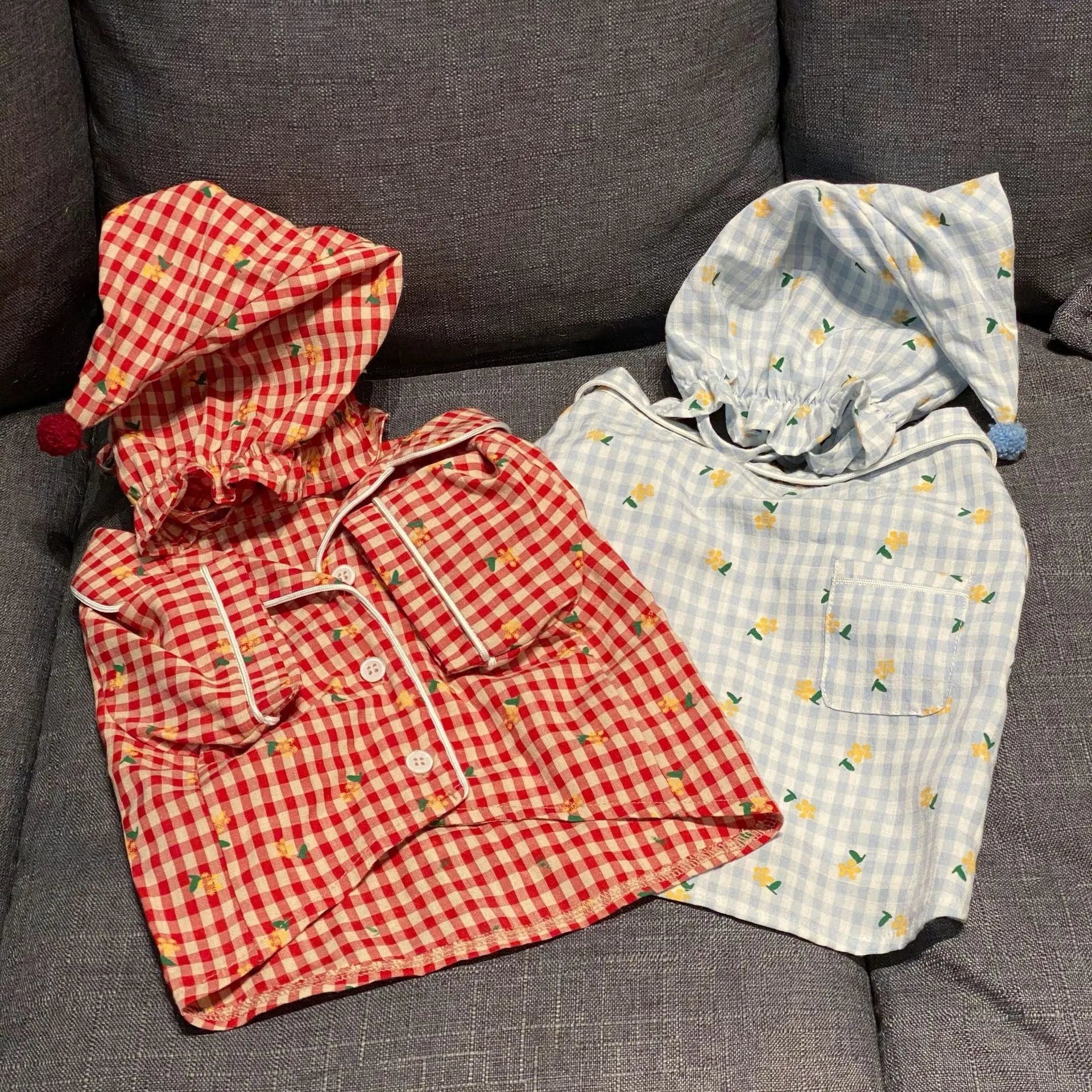 Red cotton pet pyjamas with attached hat on a teddy schnauzer dog
