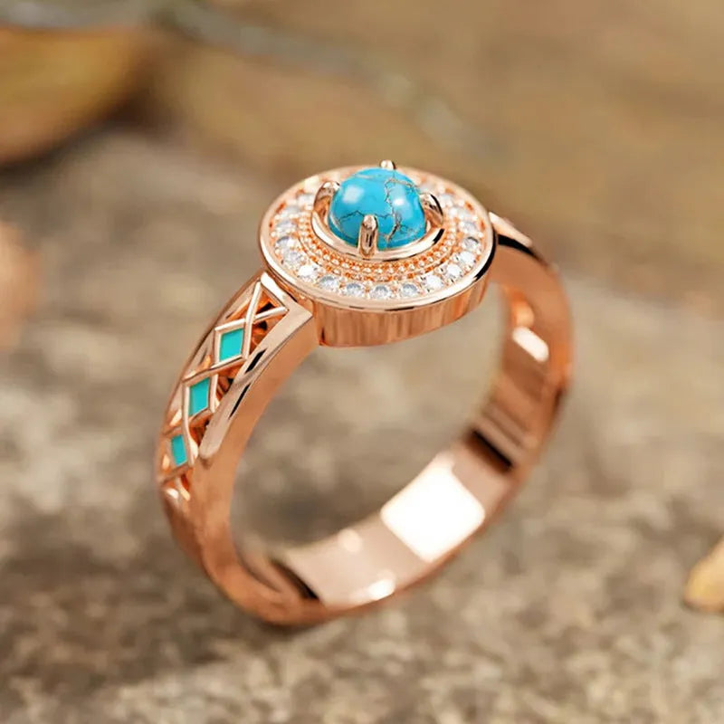 Rose gold geometric women's ring with turquoise inlaid zircon on a copper band.