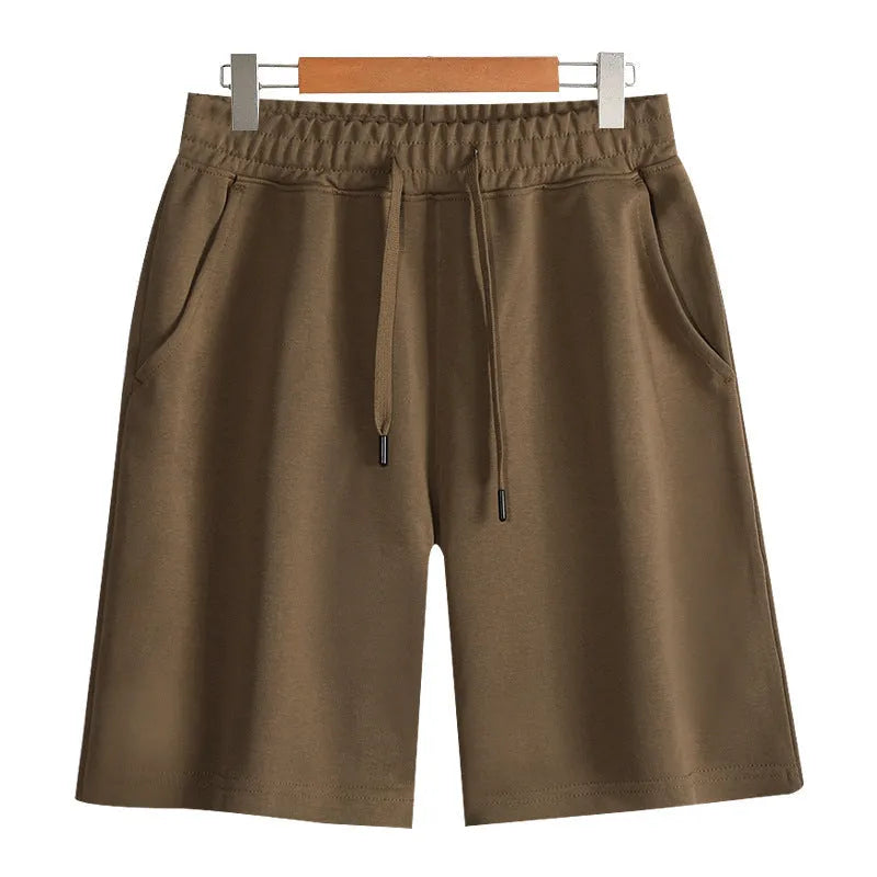 Men's and women's straight-leg cotton sports shorts in fifth length on a neutral background