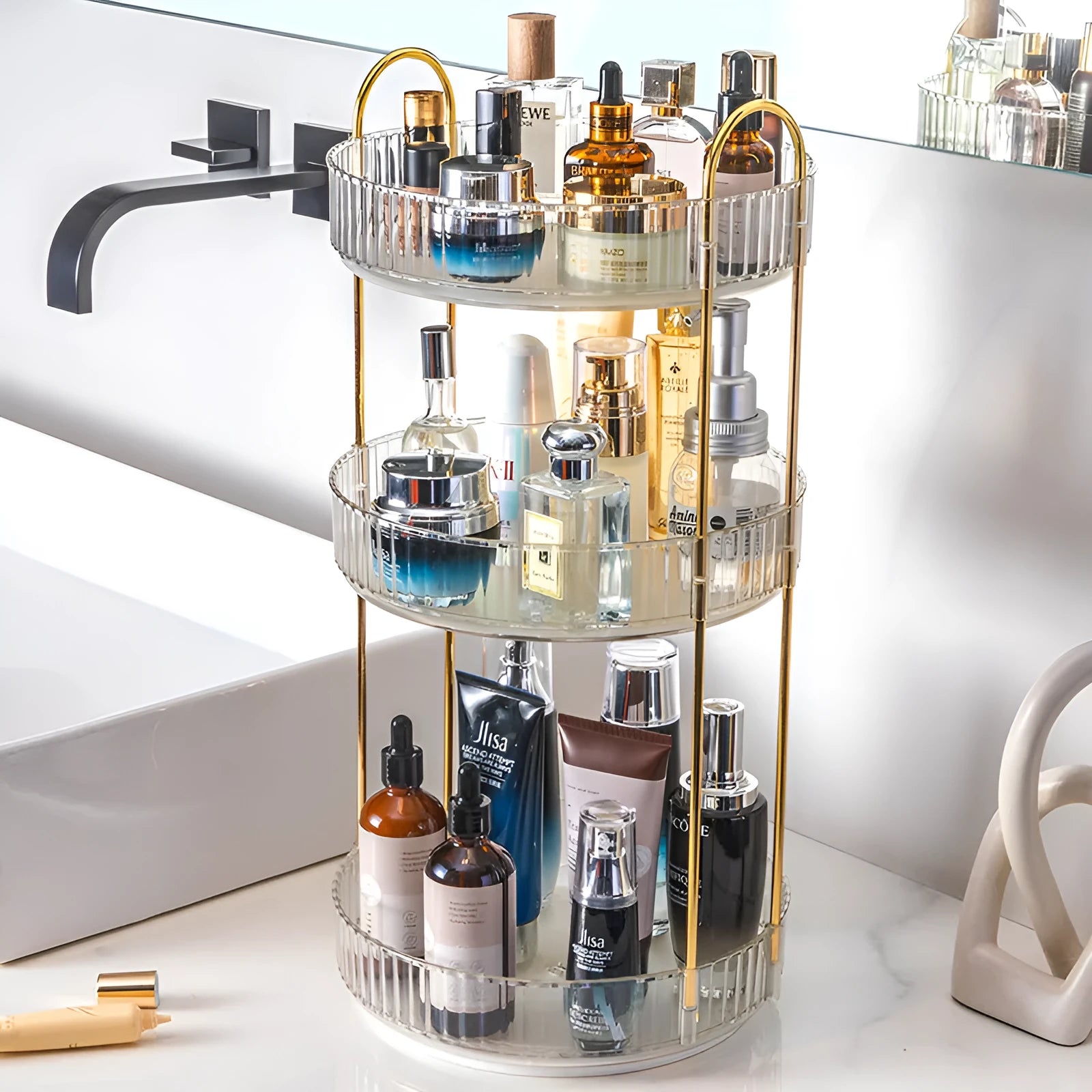 Three-layer rotating bathroom cosmetics storage rack in green, yellow, and white on a desktop