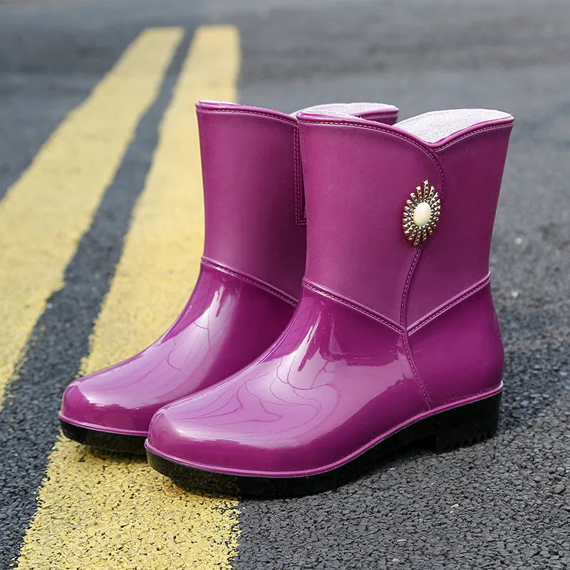 Women's mid-length PVC rain boots in purple, black, or beige with non-slip sole