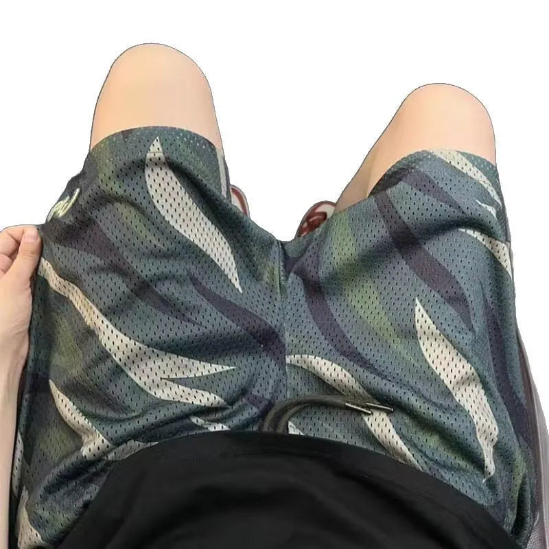 Men's camouflage mesh shorts with straight leg design on mannequin