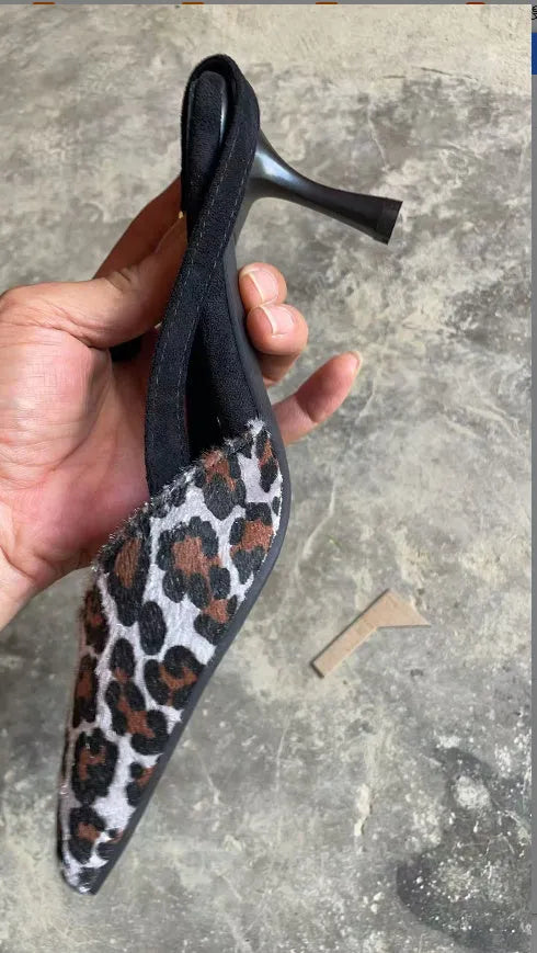 Women's leopard print suede high heel sandals with a pointed toe on a white background.