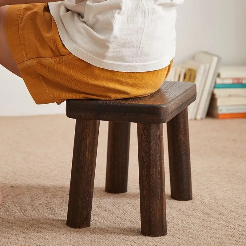 Distressed solid wood changing stool with bracket structure for hallway or living room.