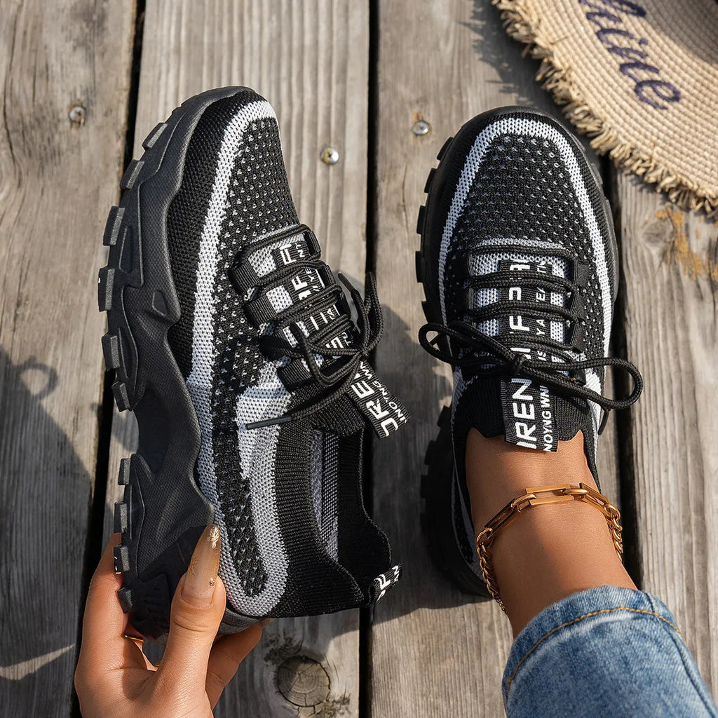 Women's Flyknit mesh lace-up sneakers in a selection of colours, showing round toe and flat rubber sole.