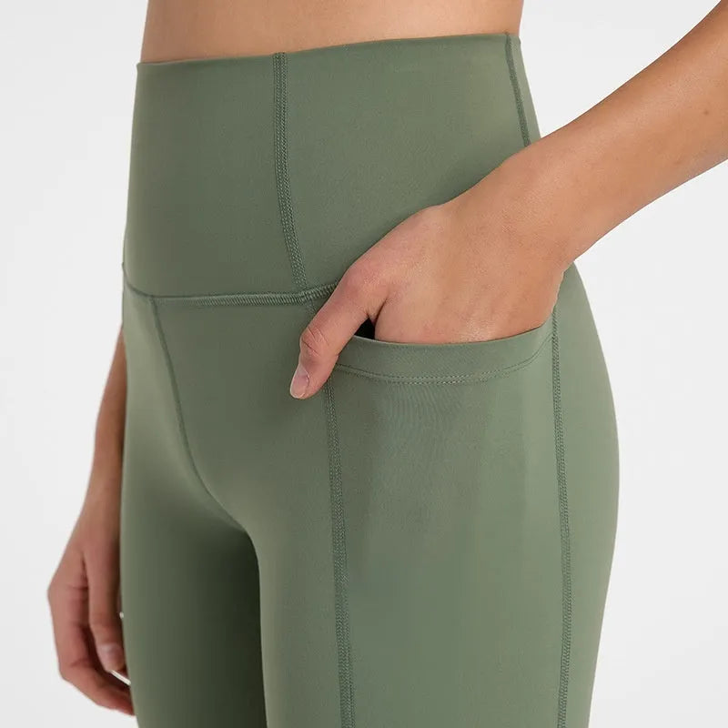Women's tight-fit cotton blend sports shorts in short fifth pants length on a neutral background.