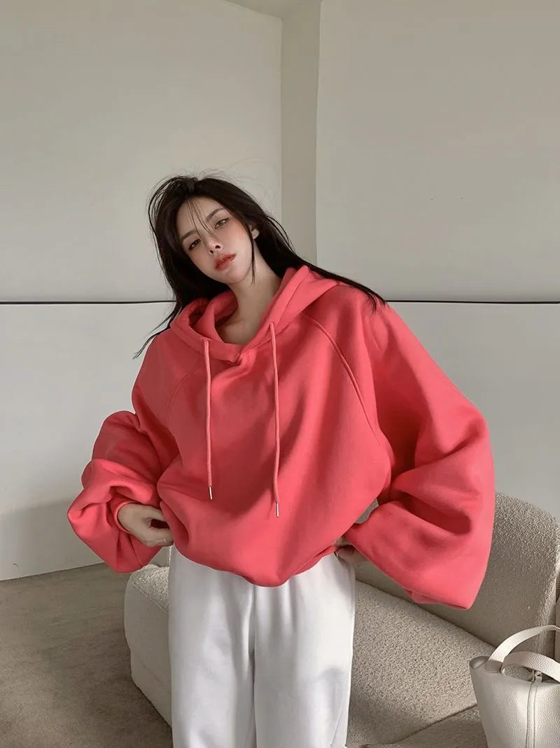 Women's watermelon red Mulberry Silk hooded sweater on a hanger, showing loose fit and front design.