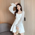 White women's long sleeve dress with chiffon patchwork detailing and a long, slimming skirt.