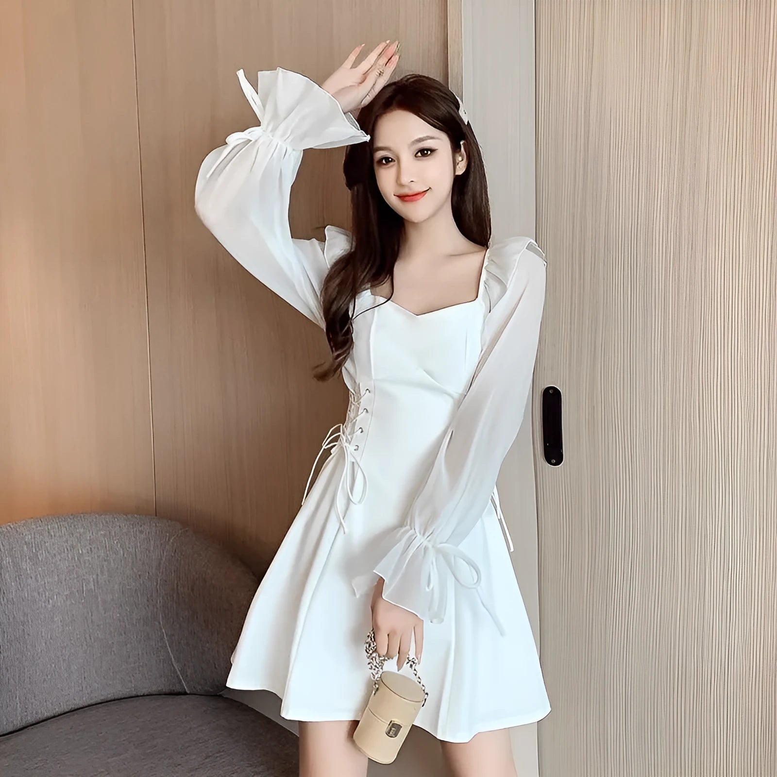 White women's long sleeve dress with chiffon patchwork detailing and a long, slimming skirt.