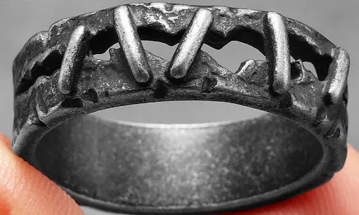 Stainless steel punk stitch ring with double ring design in dark colour, shown on a finger.