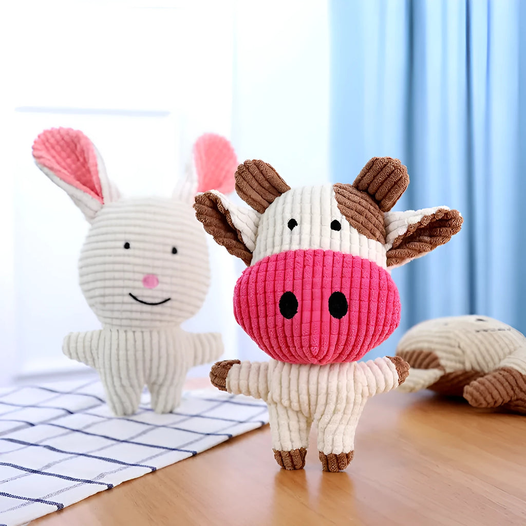 Animal-shaped plush dog chew toy with squeaker in assorted colours including blue, brown, and cow print.