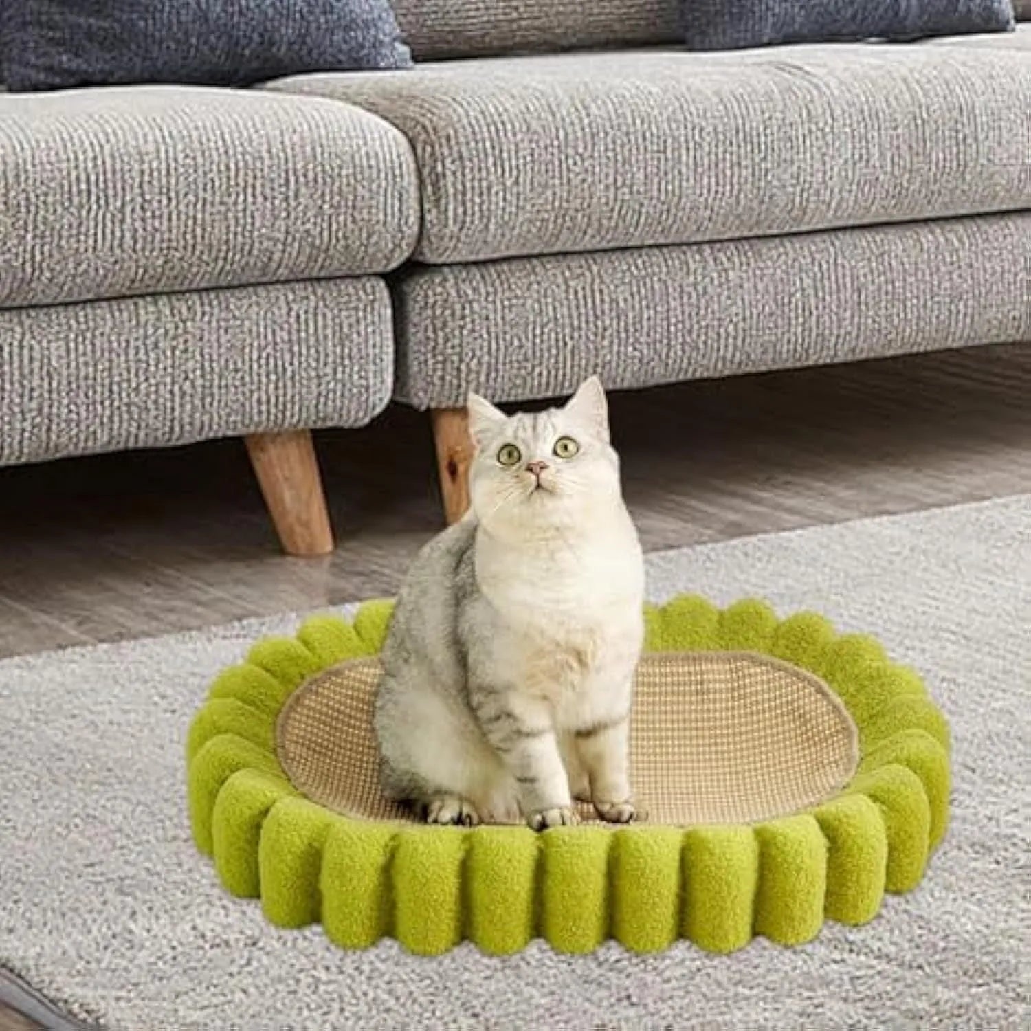 Green oval cat scratching pad with sisal surface measuring 65cm long, functioning as both scratcher and lounger bed