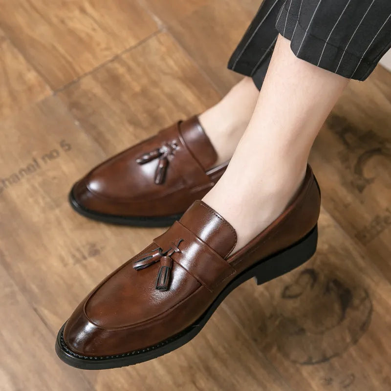 Men's black slip-on loafers with tassel detail and rubber sole for business casual wear