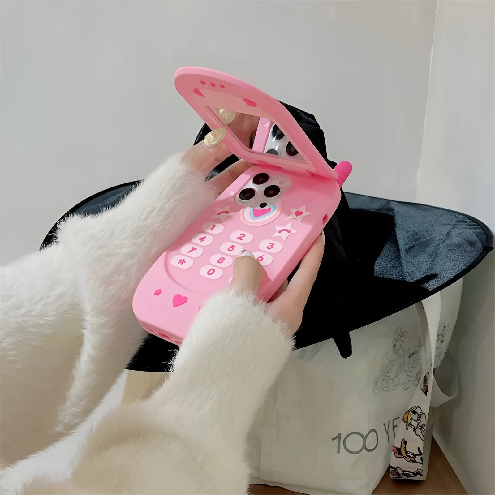 Light pink silicone flip phone shape mirror case for iPhone showing built-in mirror and nostalgic design