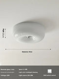 American-style antique finish ceiling lamp with cream coloured shade in bedroom setting