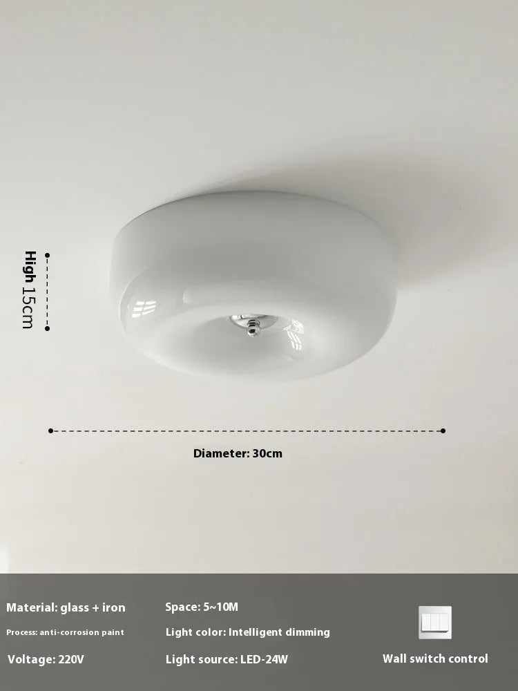 American-style antique finish ceiling lamp with cream coloured shade in bedroom setting
